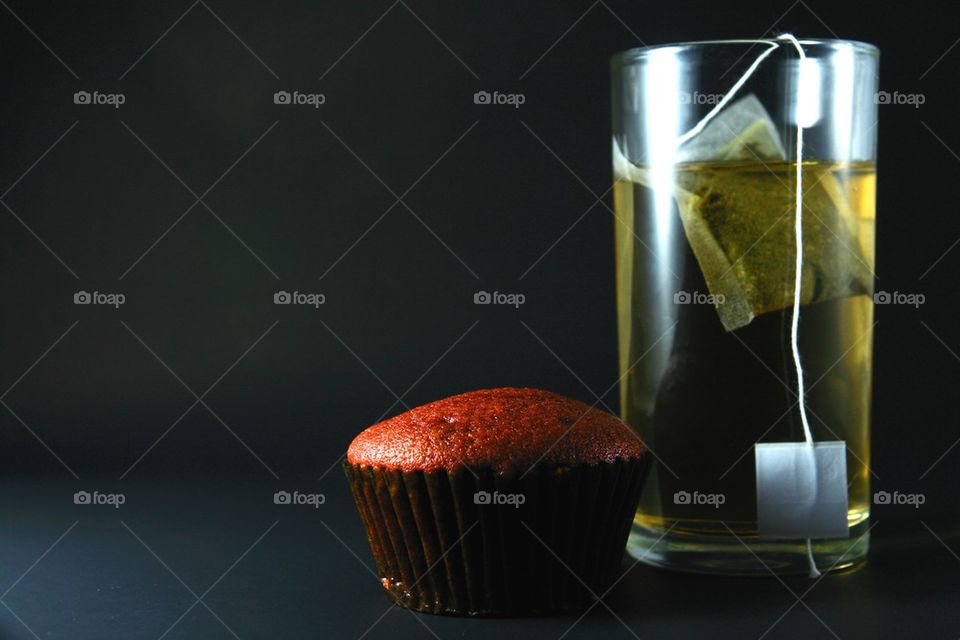 red velvet cupcake and a glass of tea