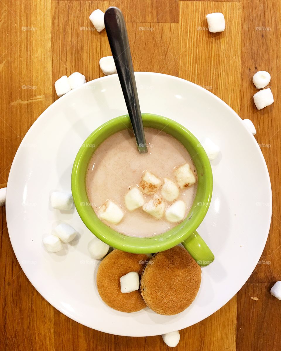 High angle view of coffee with marshmallow and cookie