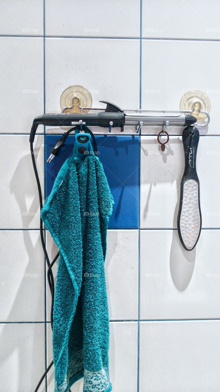 face towel, curling iron and bathroom accessories