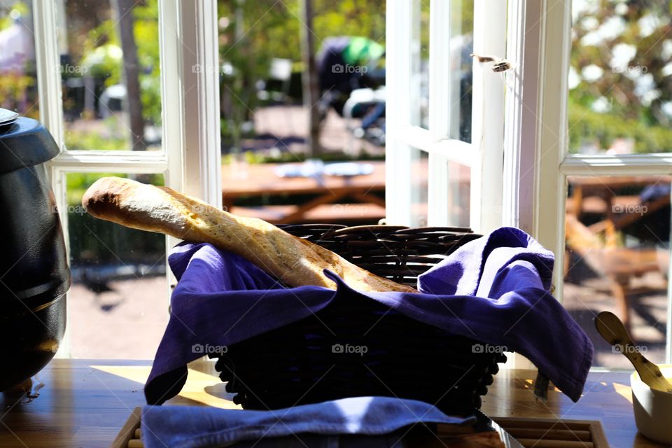 Spring in the window . Bread in a basket in an open window 