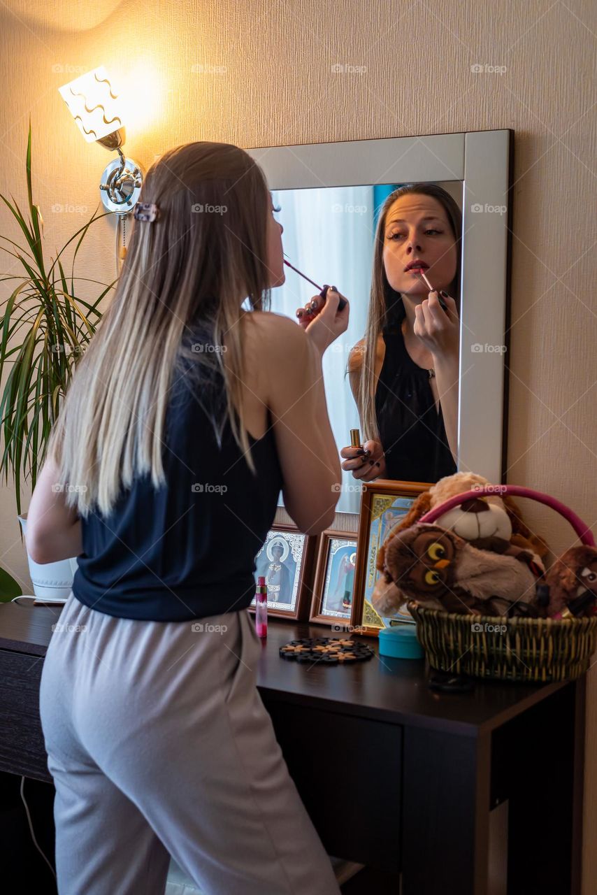 Beautiful girl reflected in the mirror