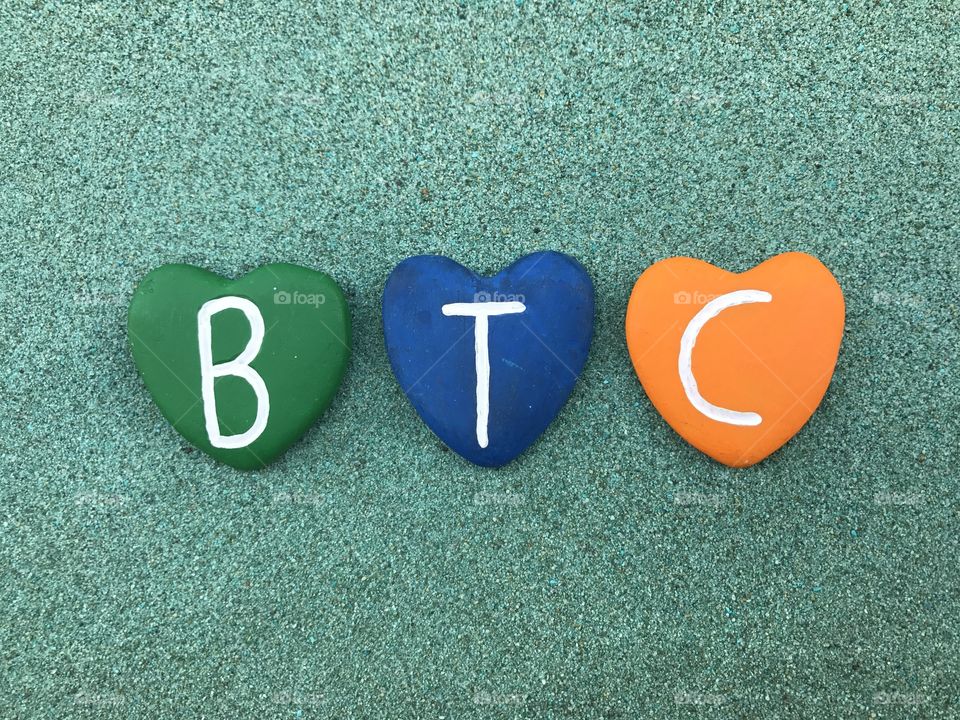 
BTC, Bitcoin, worldwide cryptocurrency and digital payment system with colored heart stones