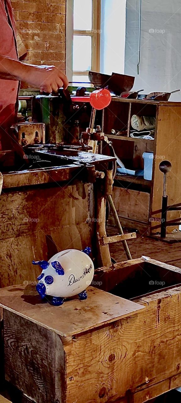 Glassblowing the old fashioned way is a dying art. It makes those who remain the more dedicated to the craft. In a small workshop in “Freyung”, Bavaria, Germany a small piece of hot glass was just taken out of the furnace. 2023. Hypnotic Productions