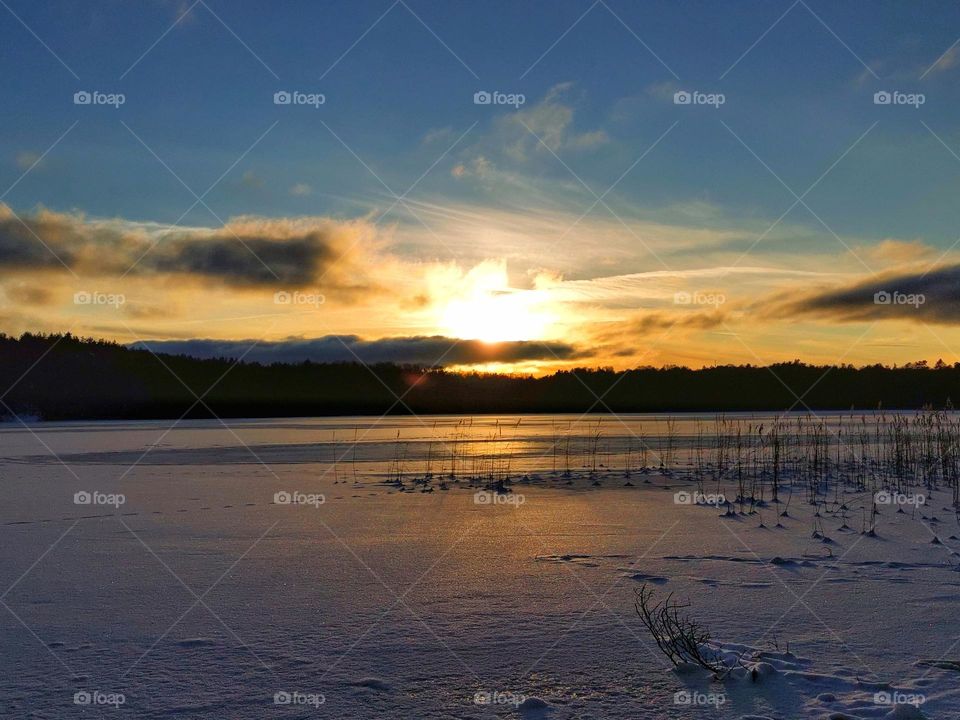 Golden sunset at winter lake