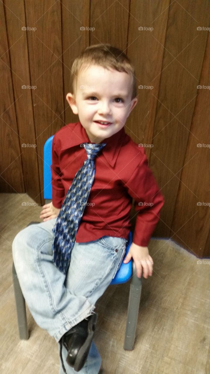 Portrait of smiling boy sitting on chair