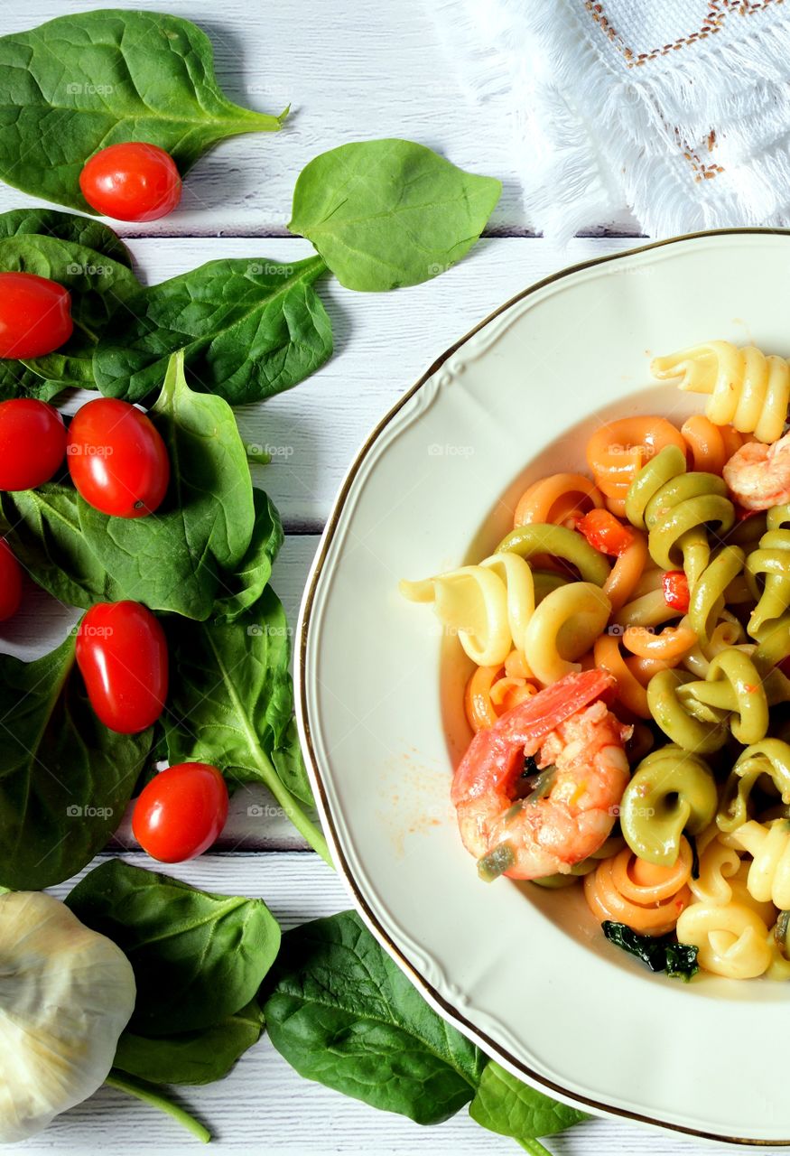 Close-up of pasta with prawns and vegetables