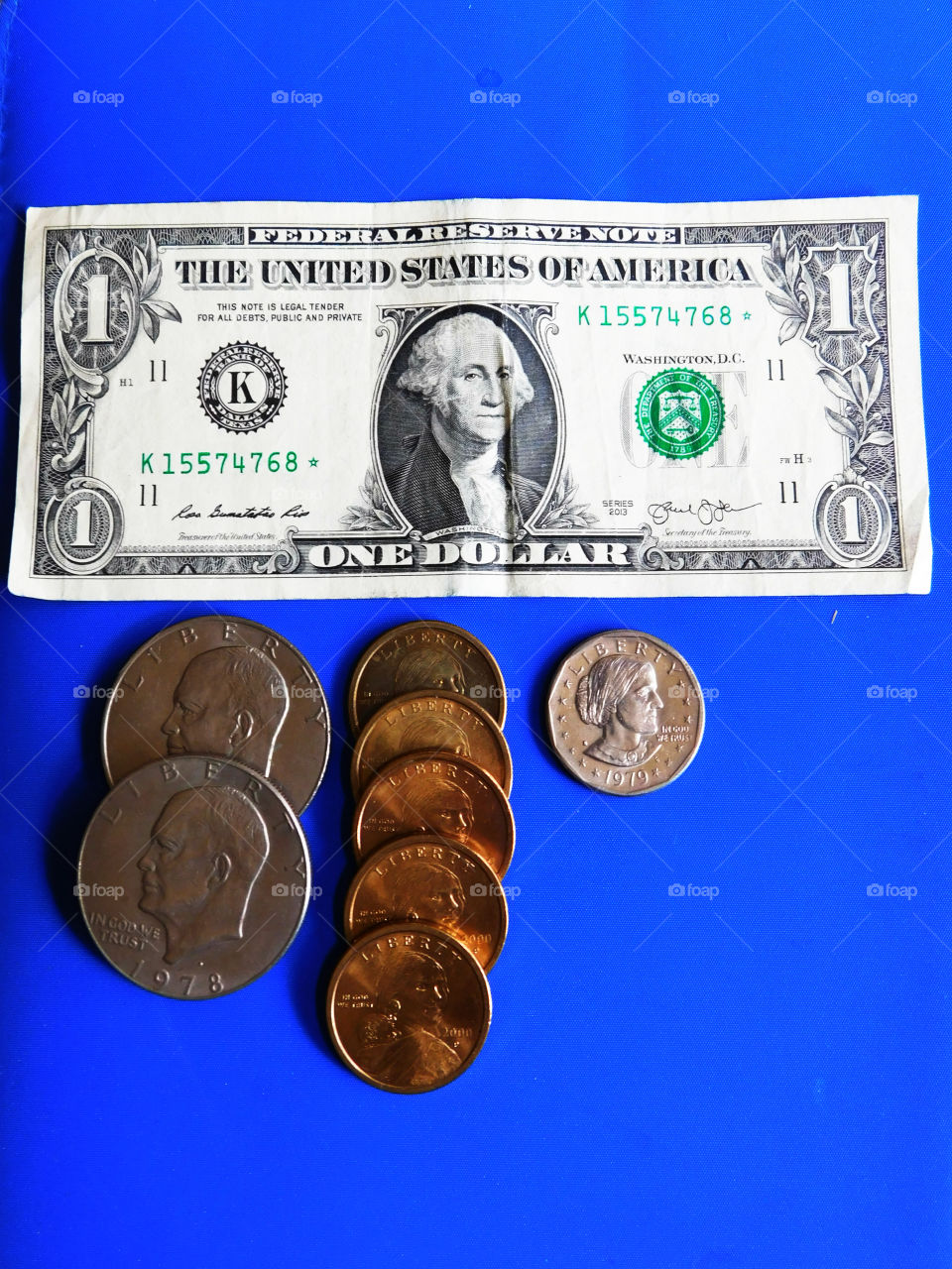 One dollar in four different settings!
One dollar bill,and three coins!