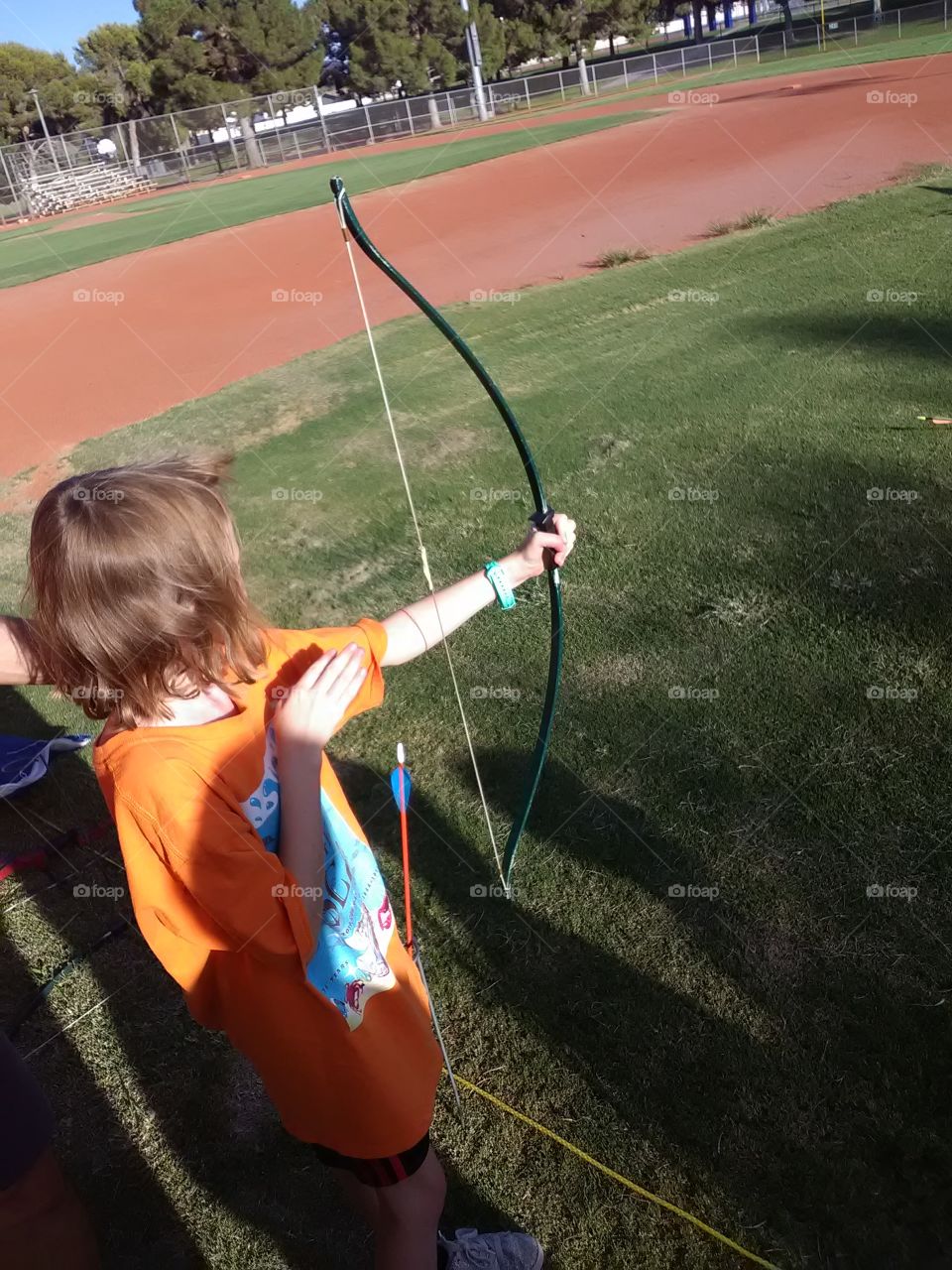 my daughter at day camp 2019 getting down learning the archery.