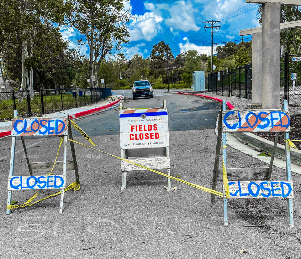 Roadblock and caution signs at a park due to coronavirus pandemic panic 