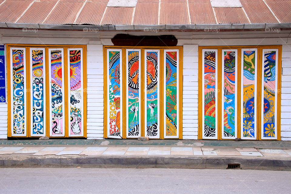 Art at the door, a wooden house.