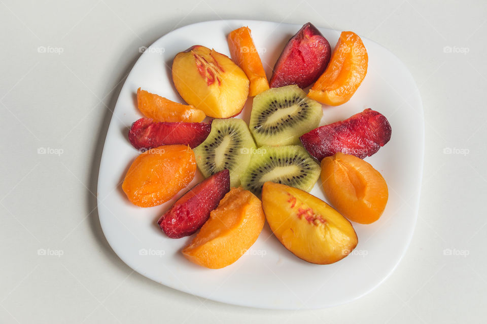 Fruit salad of apricot, blue plum, kiwi and peach