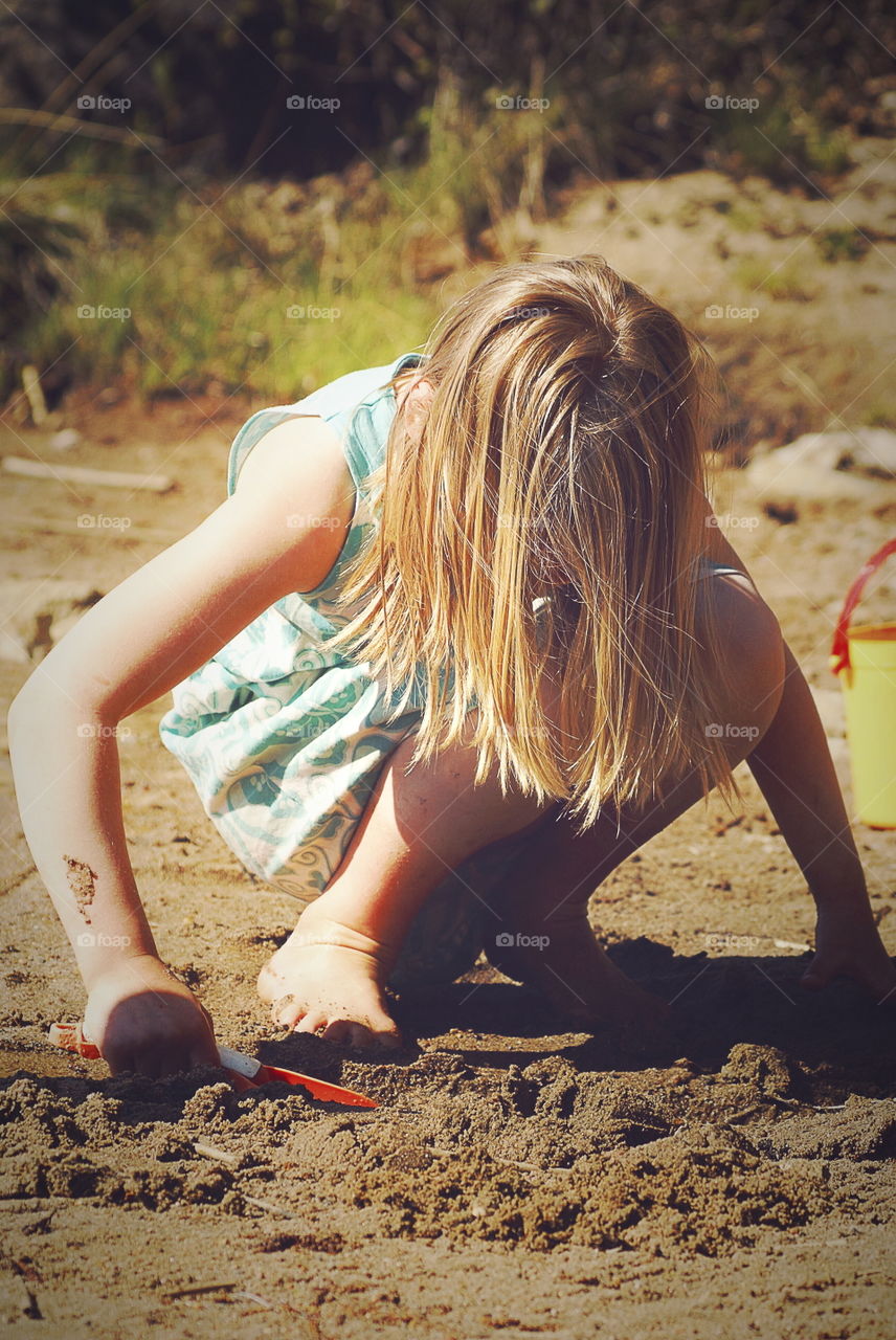 Girl playing at the beach