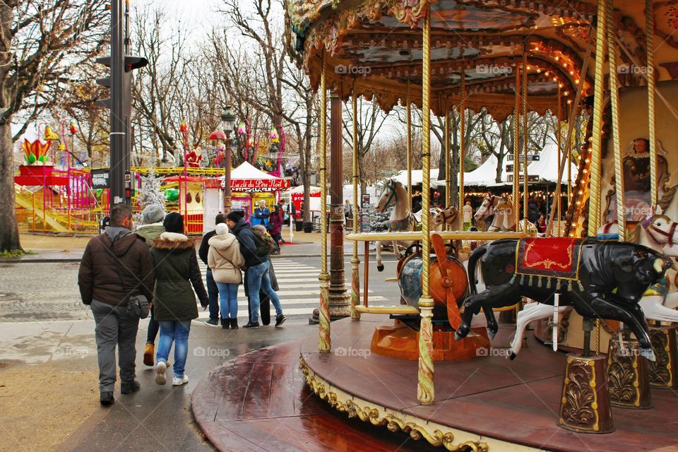 People and carousel horses in the city