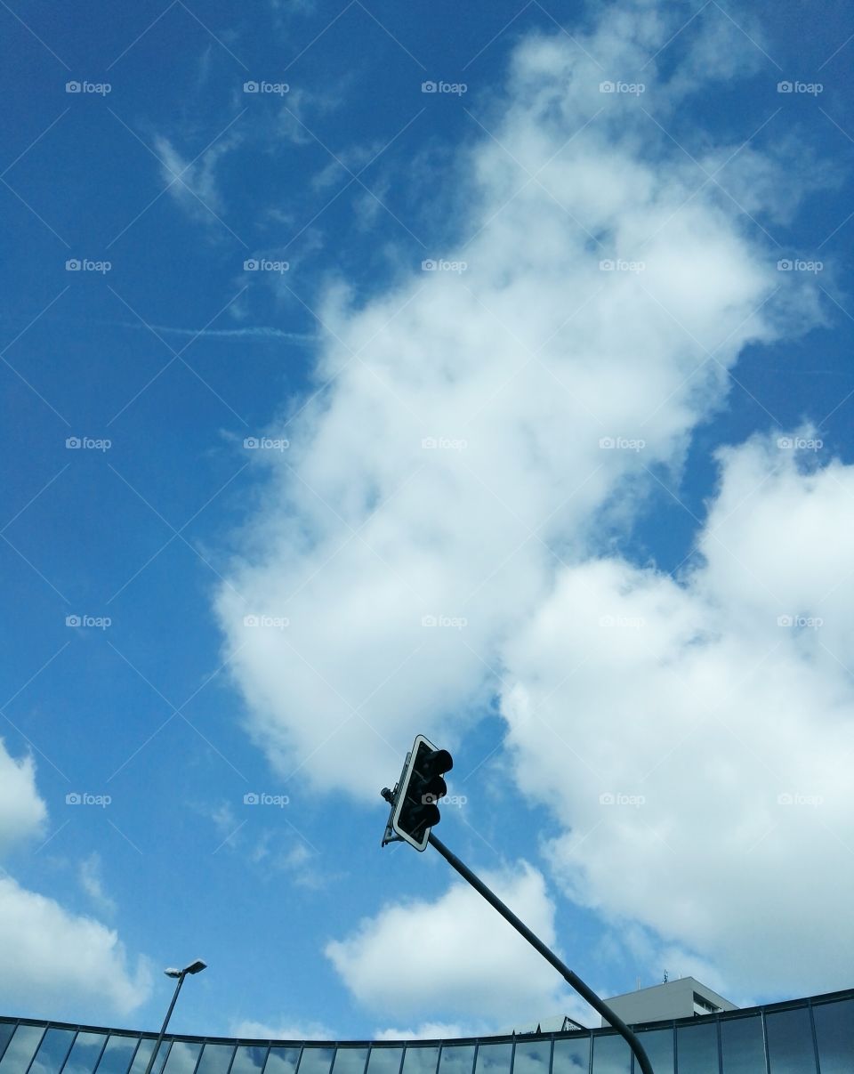 Roof against cloudy sky