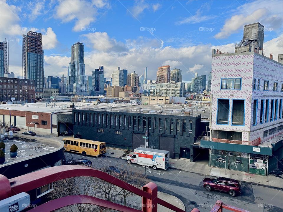 This is the view from the top of the staircase of the “Pulaski Bridge” at “Newtown Creek” on the “Greenpoint”, Bklyn side of the bridge. In the distance we see “Manhattan” with its various skyscrapers. 2023. Hypnotic Productions