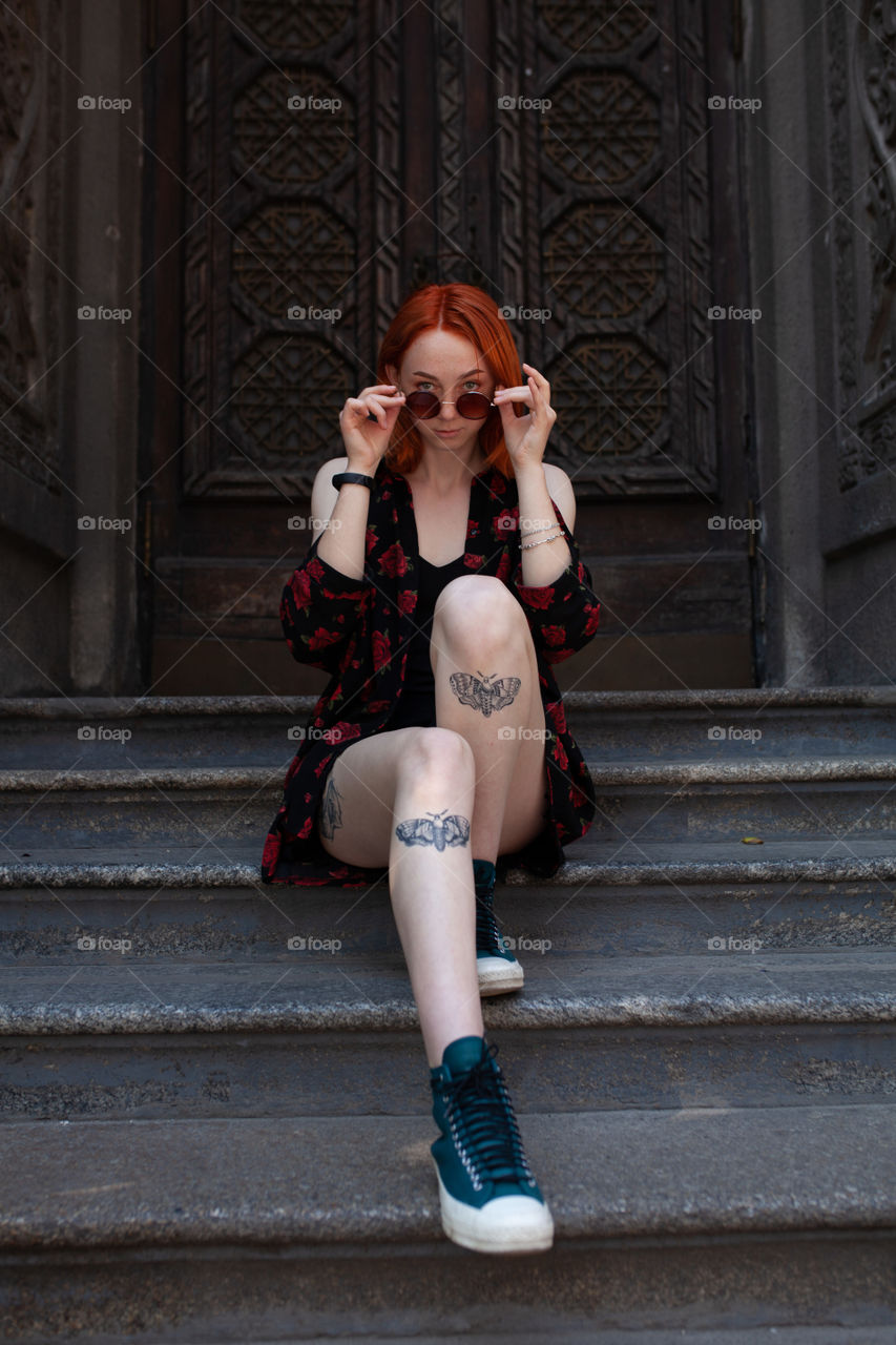 young woman with tattoos on her legs