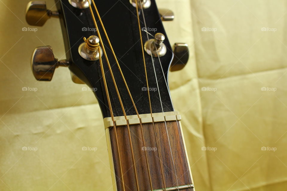 acoustic guitar on Golden textile