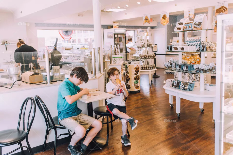 Kids eating ice cream at the ice cream parlor 