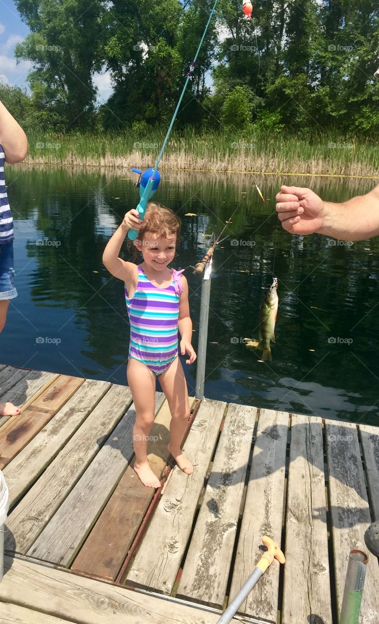 Fishing at Great Grandma’s house and catching the first fish of the day, which also happened to be the biggest fish of the day.