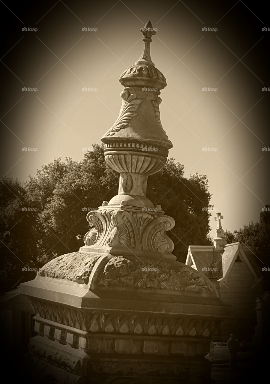 an old gravesite where an ornate monument now leaning