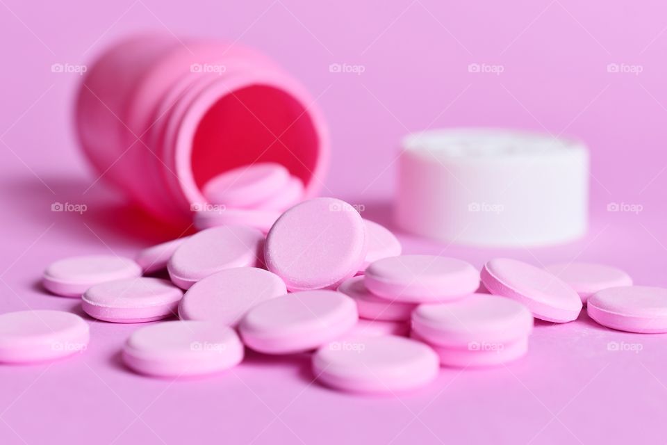 Pink tablets on a pink background 