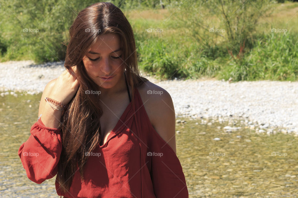 Beautiful woman standing by a lake