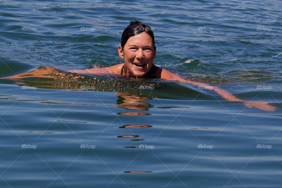 Happy Woman Swimming In Lake