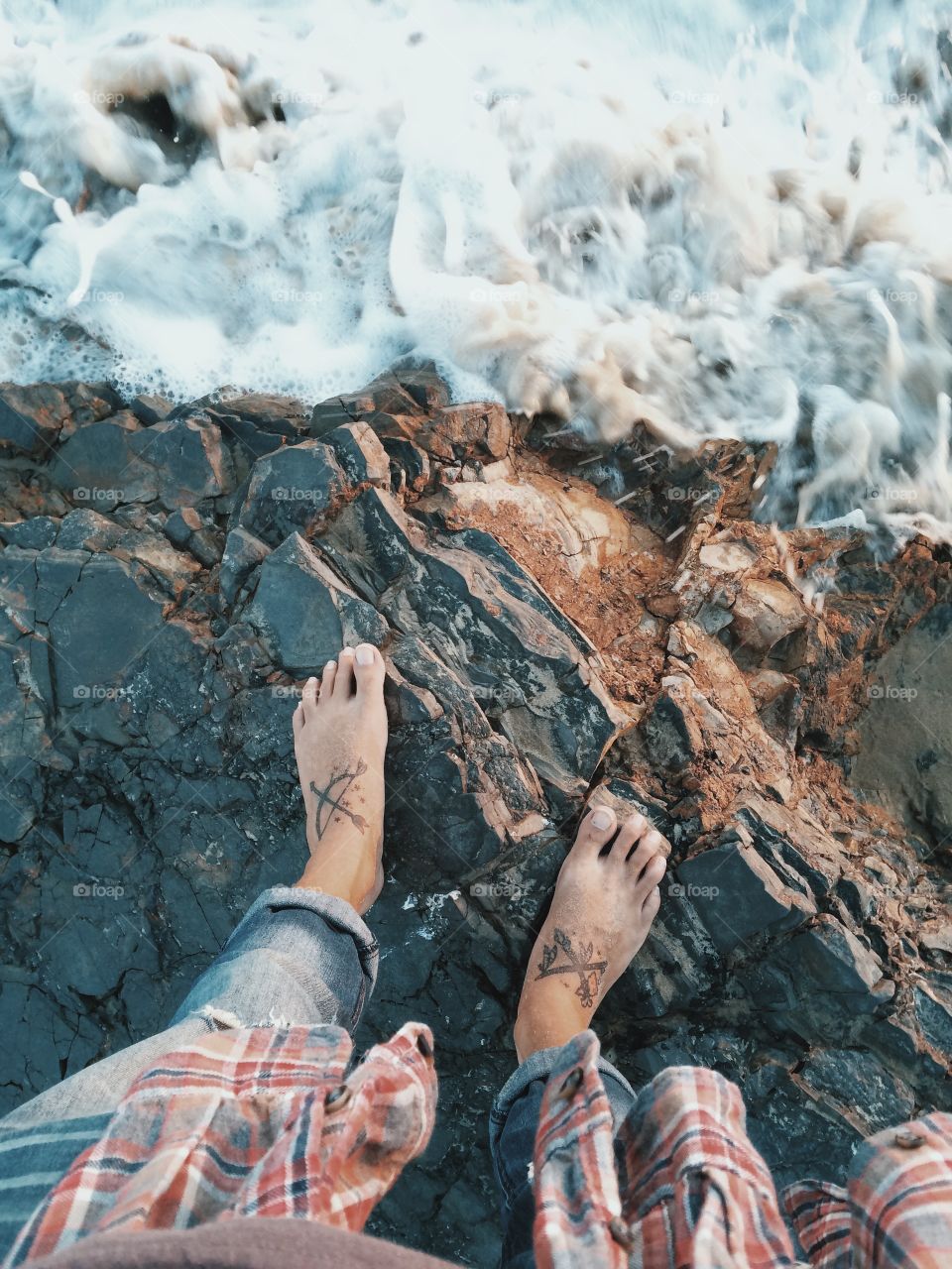 Me standing on a rock in the ocean at sunset. 