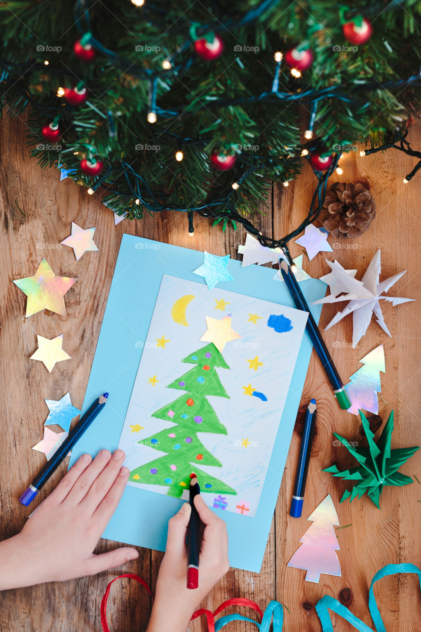 Girl drawing christmas card