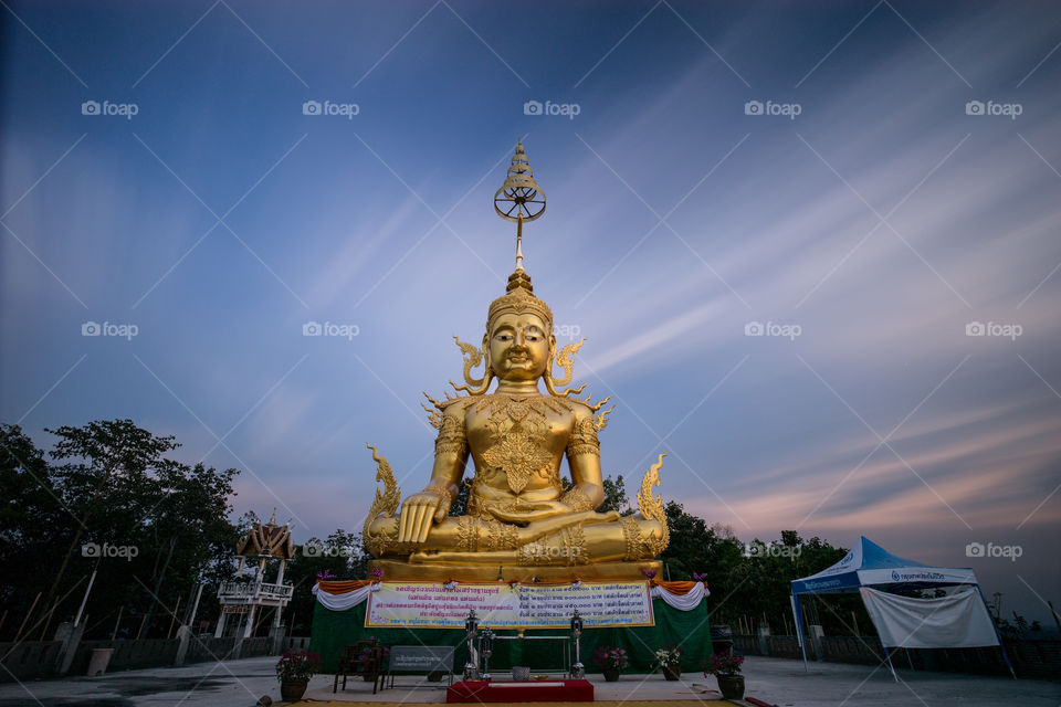 Statue of Buddha with moving cloud