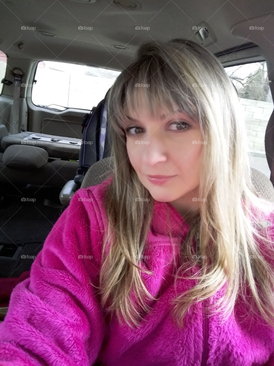 Close-up of young woman in car