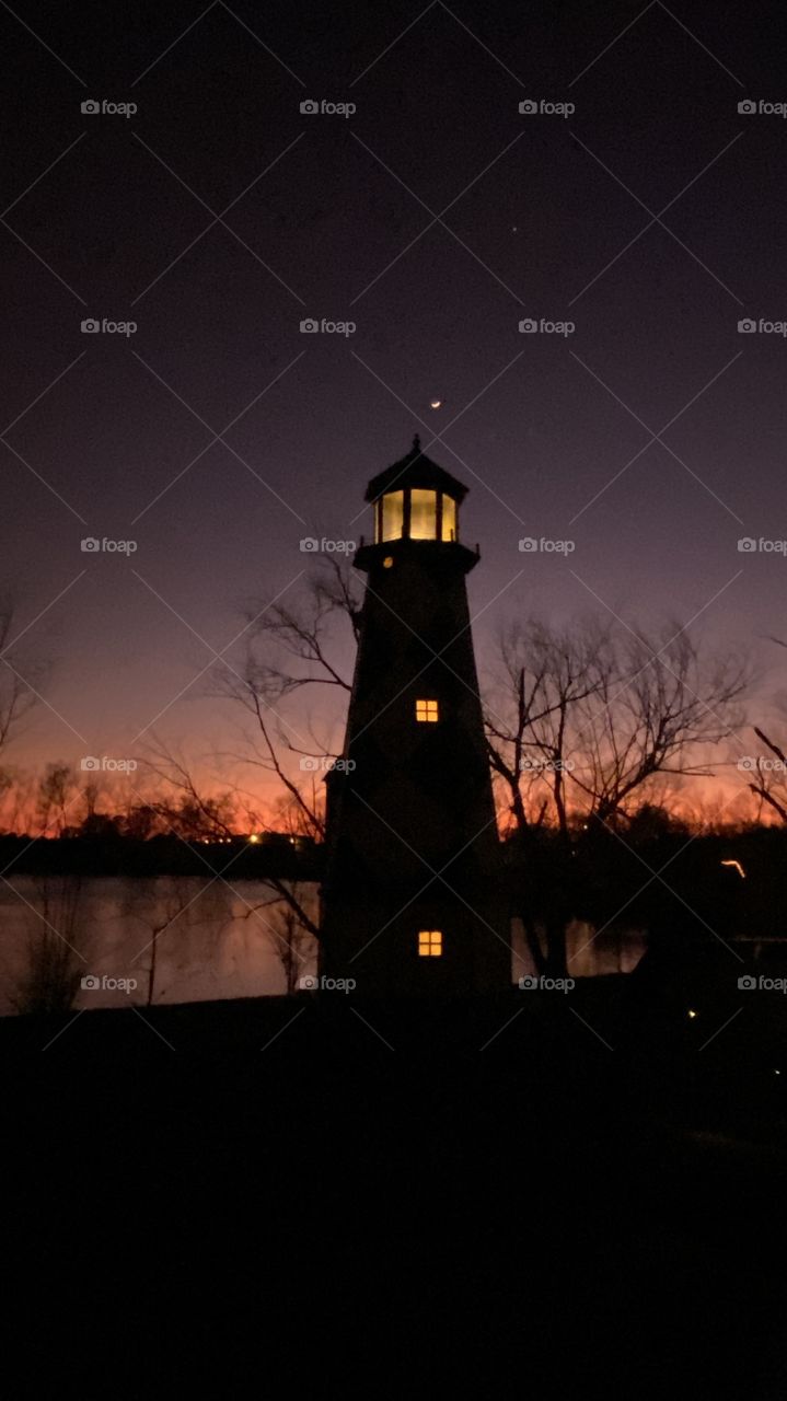 Majestically visible Lighthouse, lights on Beautiful Backlit Horizon colors of the Night. Twilight was Gorgeous. Night Sky with Last Quarter moon growing more each night Luna Bright in the Clear Sky.