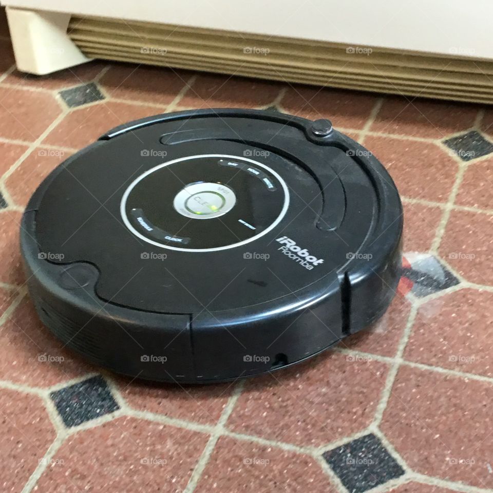 i Robot Vacuuming The Kitchen Floor