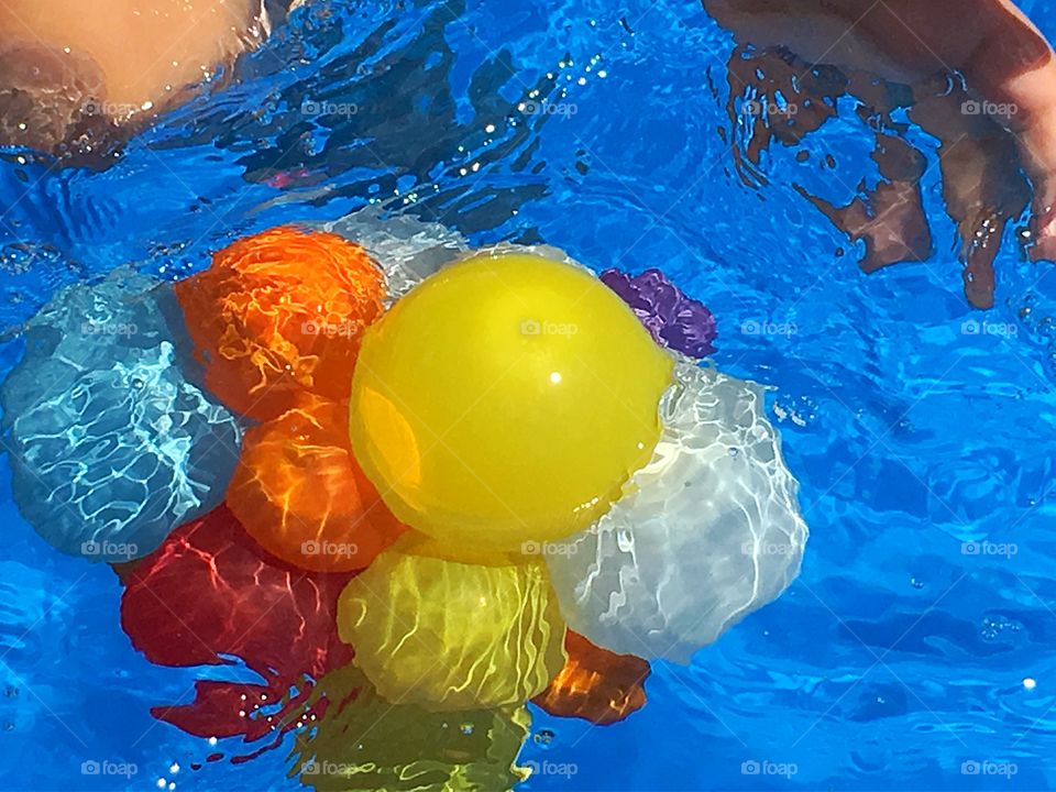 Floating water balloons. A bunch of colour in the pool with floating water balloons tied up together like a bouquet of flowers