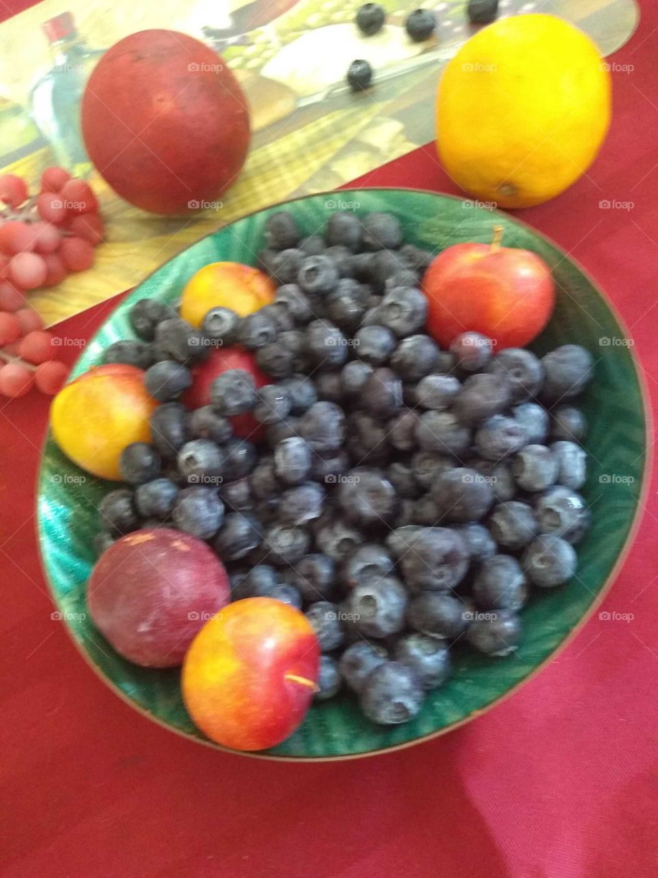 in this photo is blueberries baby peaches pomegranate and lemon