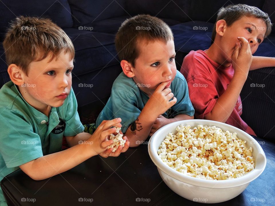 Young boys eating popcorn