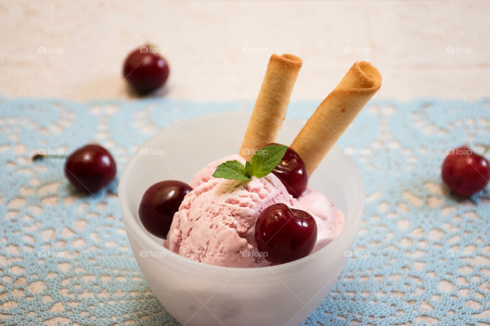 Bowl of ice cream with cherries