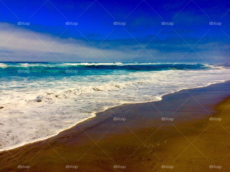 Scenic view of a sea against blue sky