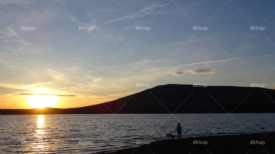 sunset on a reservoir and mountains in the Urals in Russia