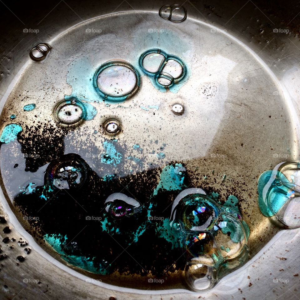 Abstract pattern made with soap bubbles from washing up liquid in a greasy pan showing beautiful iridescence. 