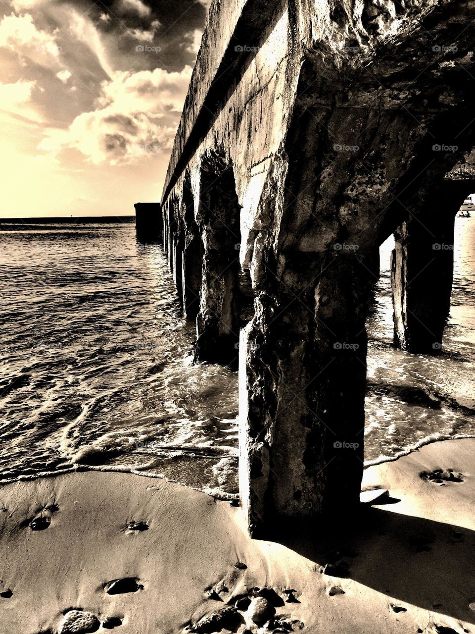 Underneath the pier, looking out on the ocean, sepia ocean view, St. Maarten ocean view, living on an island, standing underneath a pier 