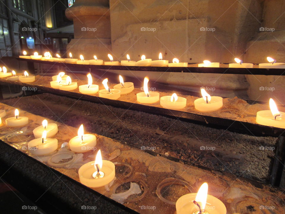 Lighting a candle at Bath abbey