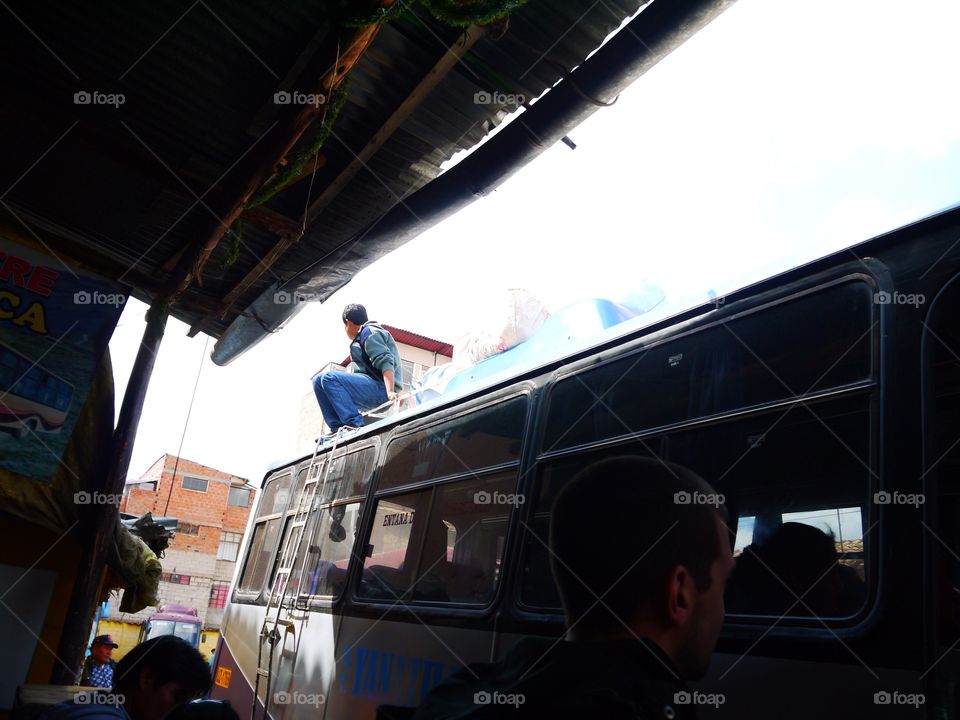 Man on a bus roof in Peru