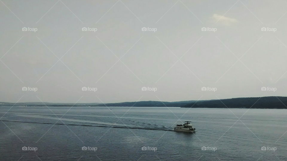 Boat crossing lake landscape