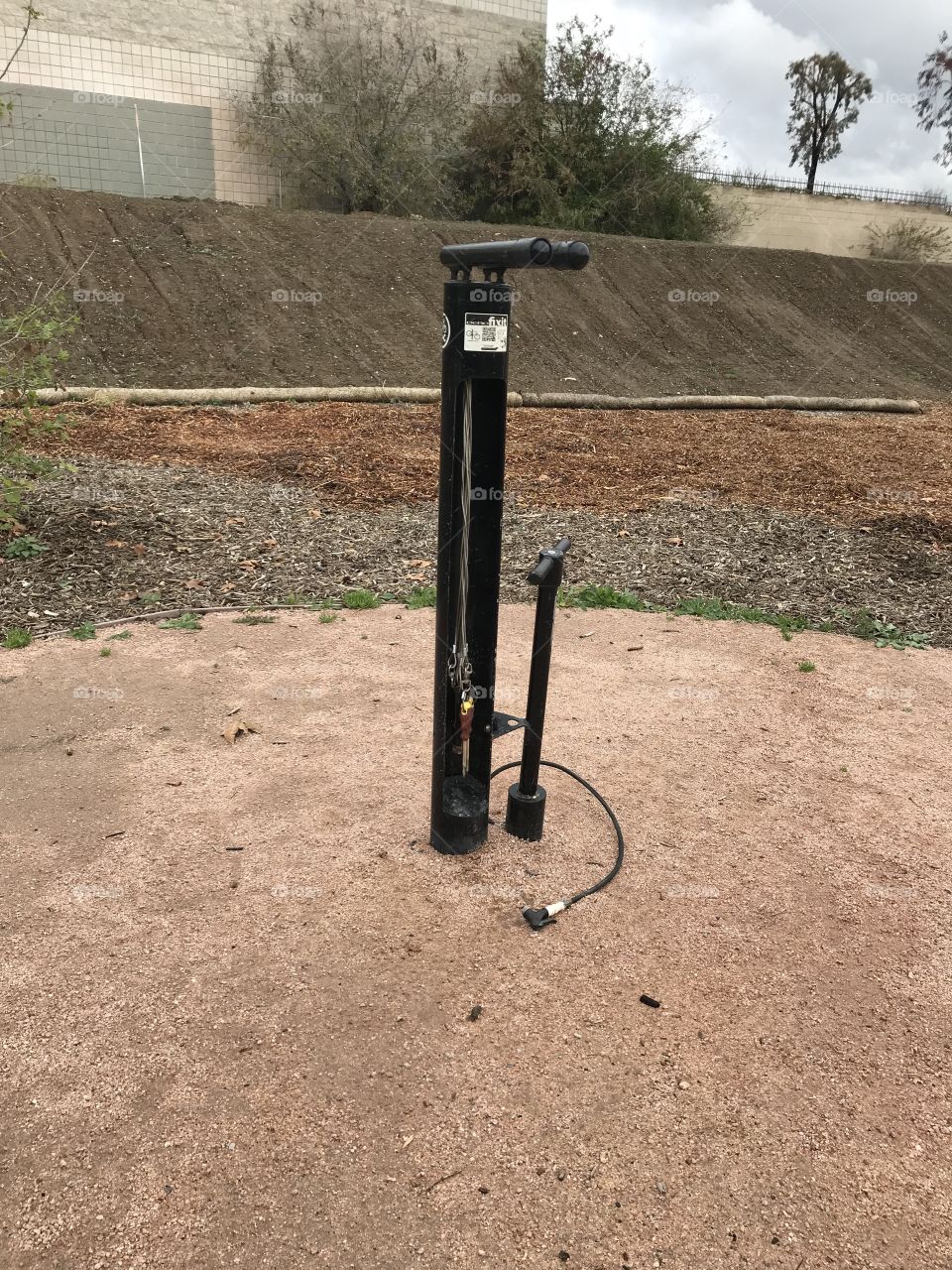 Outdoor bike pump installation on dirt