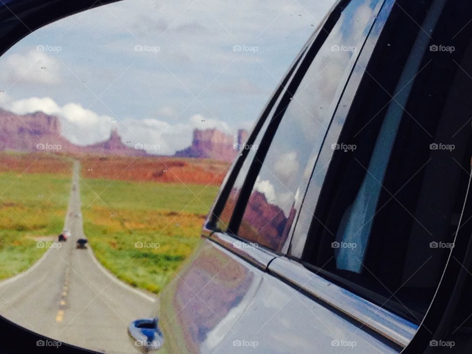 Monument Valley skyline took in the rear-view mirror