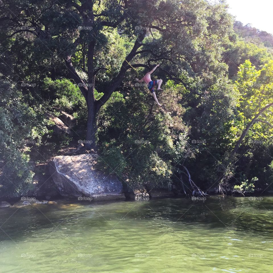 Rope swinging in Lake Austin