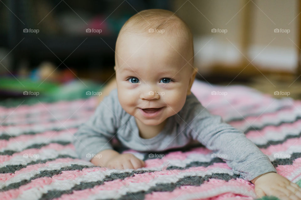 8 month old baby boy laying on blanket 