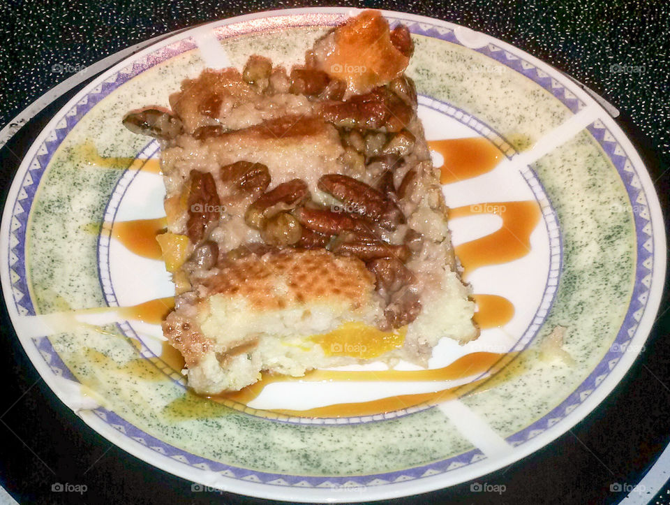 New Orleans Bread Pudding. Homemade peaches and cream bread pudding with a rum praline topping.