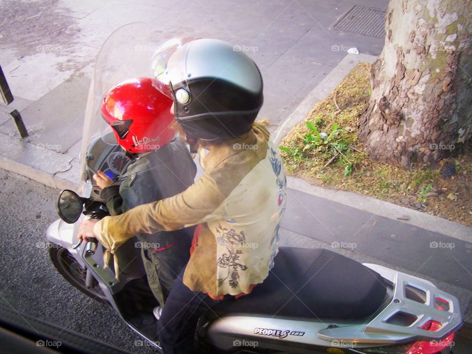 Bikers en route in Rome, Italy, red helmet, pair, couple